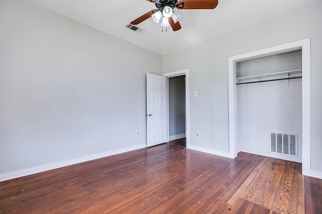 unfurnished bedroom featuring visible vents, wood-type flooring, baseboards, and a closet