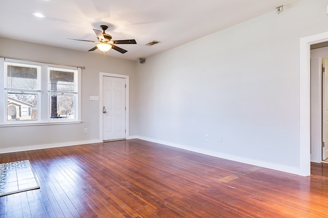 unfurnished room with visible vents, ceiling fan, baseboards, and wood-type flooring