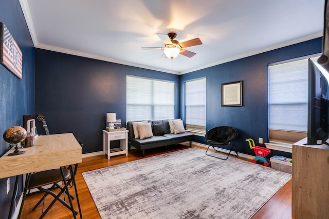 living room with dark hardwood / wood-style flooring, crown molding, and ceiling fan