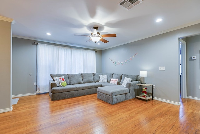 living room with ceiling fan, ornamental molding, and light hardwood / wood-style flooring