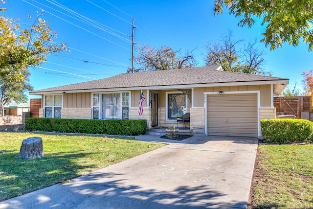 ranch-style home with a garage and a front lawn