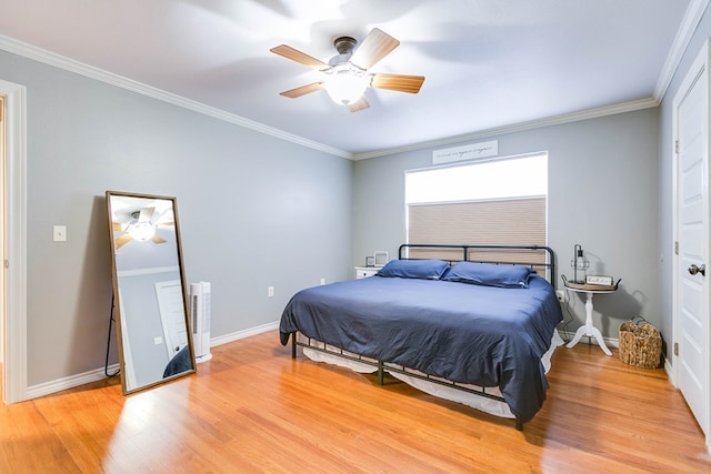 bedroom featuring crown molding, ceiling fan, and light hardwood / wood-style floors