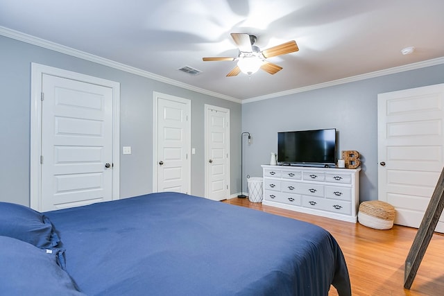 bedroom with crown molding, ceiling fan, and light wood-type flooring