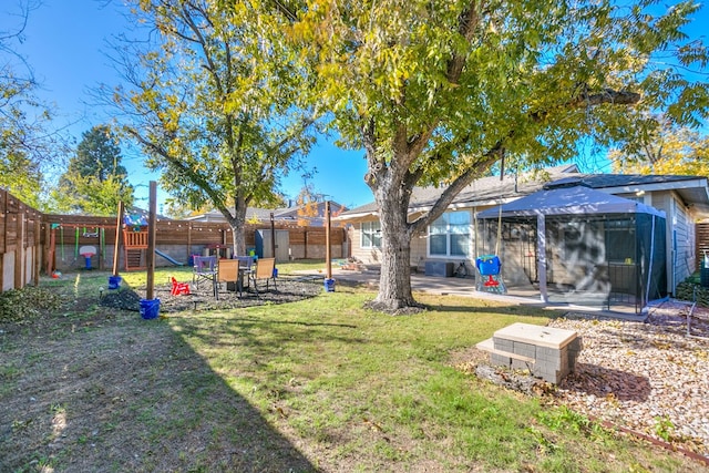 view of yard with a gazebo, a patio, and a playground