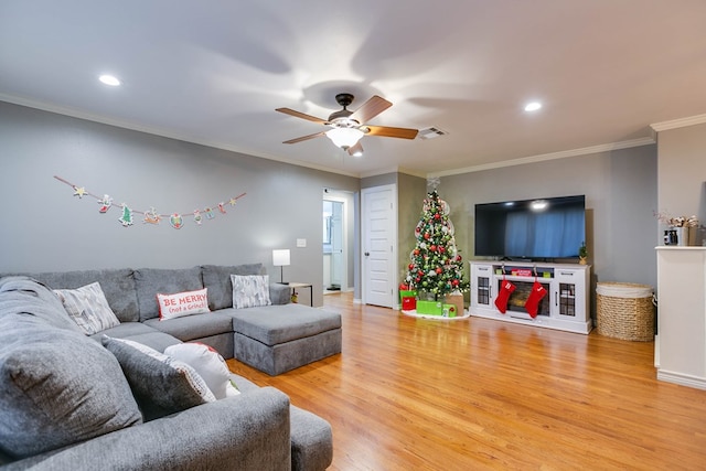 living room with ceiling fan, ornamental molding, and hardwood / wood-style floors