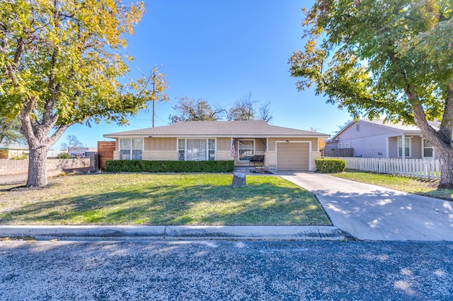 single story home featuring a garage and a front lawn