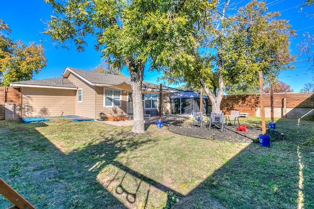 rear view of house featuring a lawn