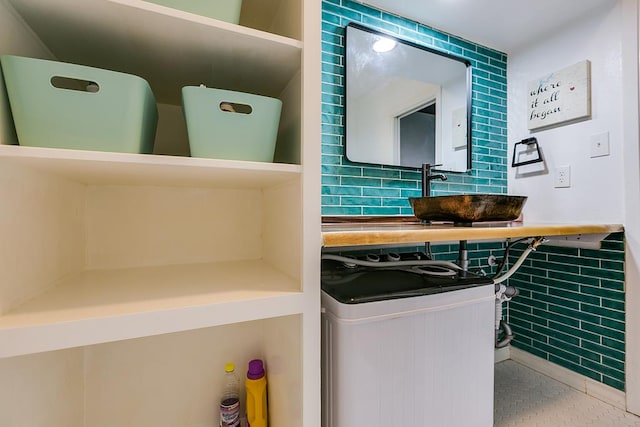 220-K W Twohig Ave, San Angelo, TX 76901 - washroom featuring a sink, washer / dryer, and tile walls
