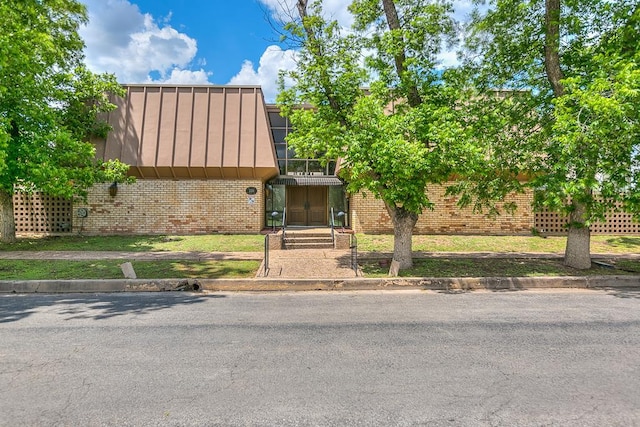 220-K W Twohig Ave, San Angelo, TX 76901 - view of front of home with brick siding and a standing seam roof