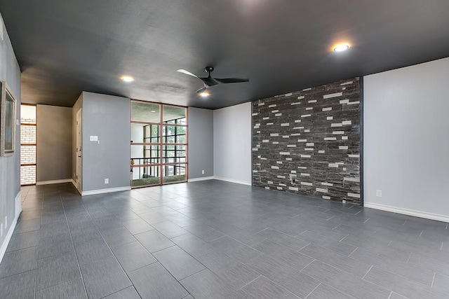 220-K W Twohig Ave, San Angelo, TX 76901 - spare room with a ceiling fan, baseboards, and floor to ceiling windows
