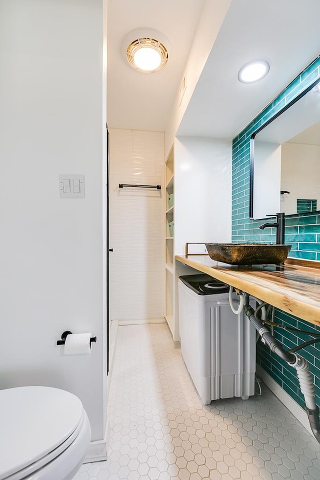 220-K W Twohig Ave, San Angelo, TX 76901 - bathroom featuring toilet, vanity, tile patterned flooring, and baseboards