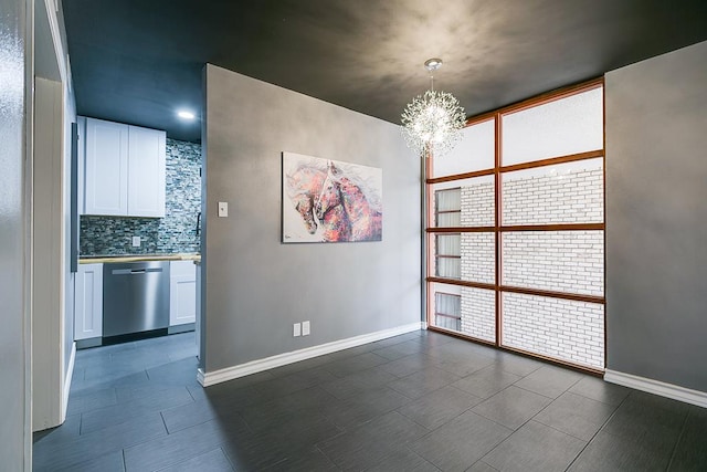 220-K W Twohig Ave, San Angelo, TX 76901 - unfurnished dining area with a chandelier and baseboards