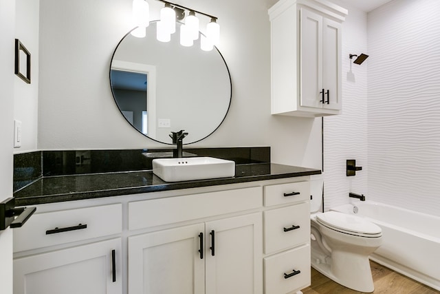 full bathroom with washtub / shower combination, wood-type flooring, toilet, and vanity