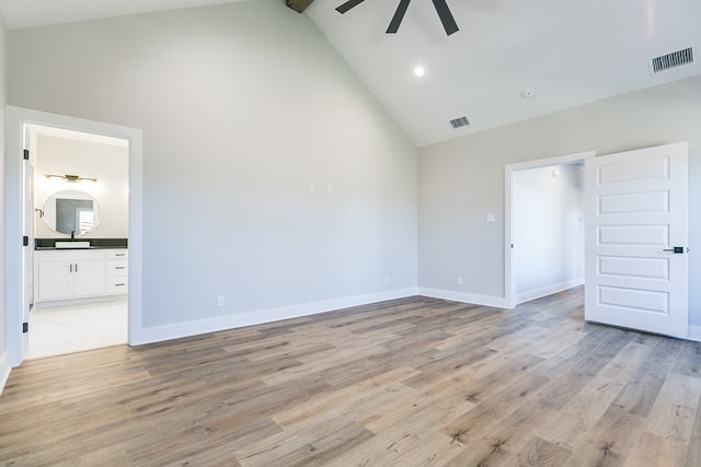 interior space with ensuite bathroom, high vaulted ceiling, light hardwood / wood-style flooring, beamed ceiling, and ceiling fan