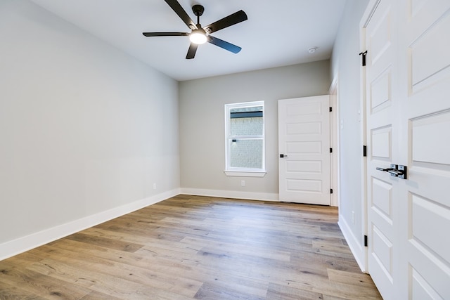 spare room with light hardwood / wood-style flooring and ceiling fan