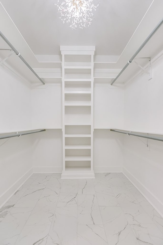 walk in closet featuring an inviting chandelier