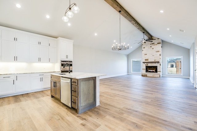 kitchen featuring white cabinetry, pendant lighting, a kitchen island with sink, and stainless steel appliances