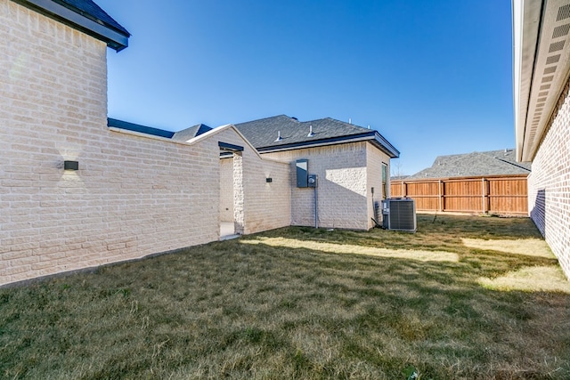 back of house featuring cooling unit and a yard