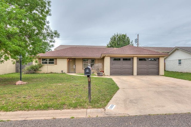 1809 N Harrison St, San Angelo, TX 76901 - ranch-style home featuring concrete driveway, an attached garage, brick siding, and a front yard