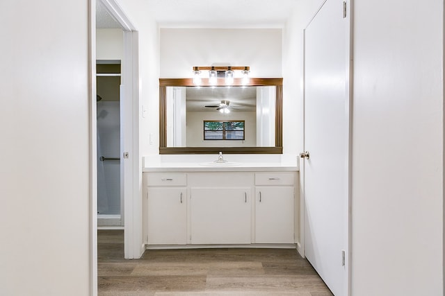 1809 N Harrison St, San Angelo, TX 76901 - bathroom featuring wood finished floors, vanity, and ceiling fan