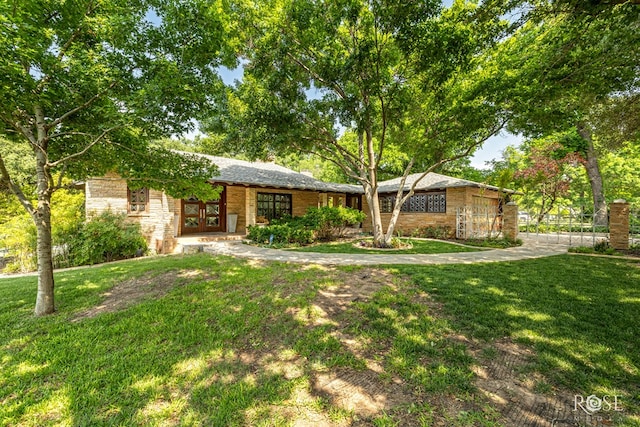 1703 Christoval Rd, San Angelo, TX 76903 - single story home featuring french doors, a front lawn, and stone siding