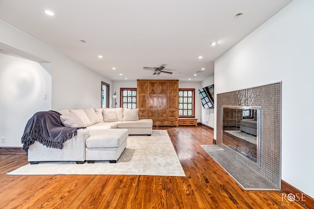 1703 Christoval Rd, San Angelo, TX 76903 - living room with wood finished floors, a tile fireplace, recessed lighting, ceiling fan, and baseboards