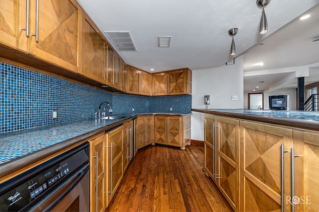 1703 Christoval Rd, San Angelo, TX 76903 - kitchen with oven, brown cabinetry, a sink, dark wood finished floors, and dark countertops