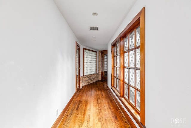 1703 Christoval Rd, San Angelo, TX 76903 - hall featuring wood finished floors, plenty of natural light, and baseboards