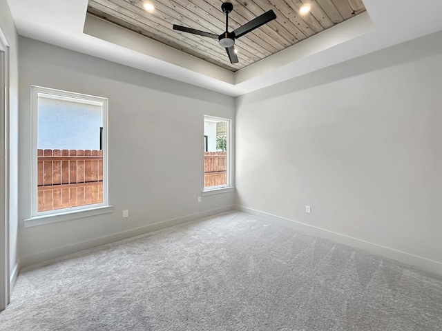1603 Paseo De Vaca St, San Angelo, TX 76901 - spare room featuring a tray ceiling, wooden ceiling, ceiling fan, carpet flooring, and recessed lighting