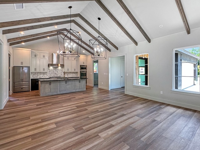 1603 Paseo De Vaca St, San Angelo, TX 76901 - kitchen with wall chimney range hood, a chandelier, open floor plan, oven, and white cabinetry