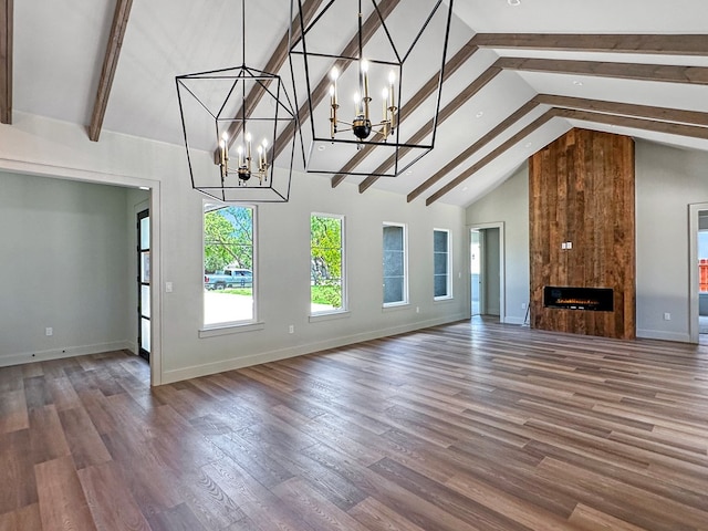 1603 Paseo De Vaca St, San Angelo, TX 76901 - unfurnished living room featuring high vaulted ceiling, a chandelier, beam ceiling, a fireplace, and wood finished floors