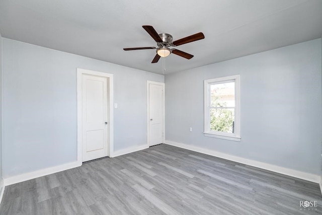 unfurnished bedroom featuring a ceiling fan, wood finished floors, and baseboards