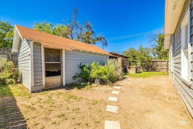 view of yard with a fenced backyard and an outbuilding