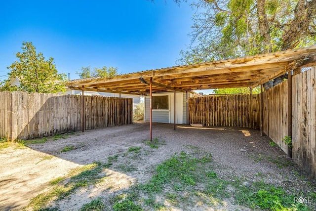 view of parking / parking lot with a carport and driveway