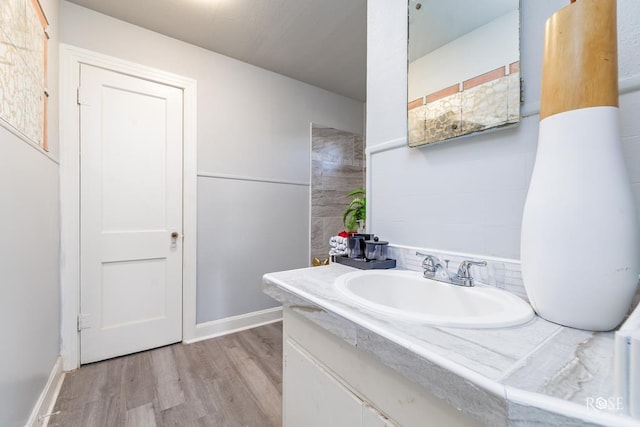 bathroom with wood finished floors and vanity