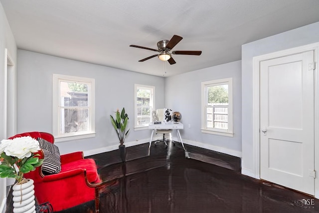 home office with baseboards, wood finished floors, and a ceiling fan