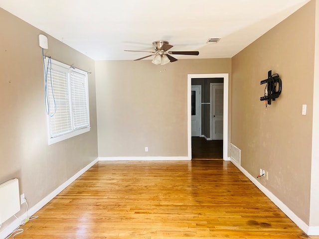 spare room featuring ceiling fan and light hardwood / wood-style flooring