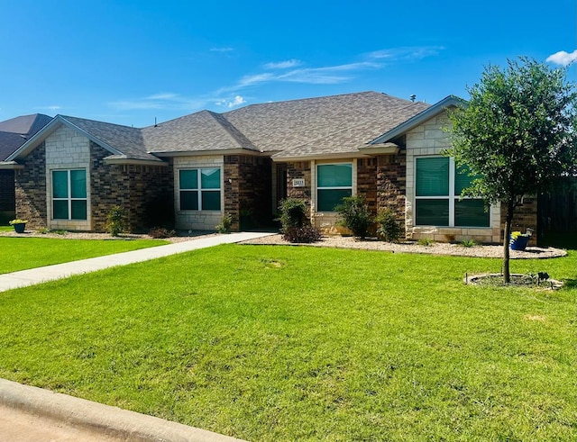 5033 Scarlet Oak Ln, San Angelo, TX 76904 - view of front facade with a front yard, a shingled roof, and stone siding
