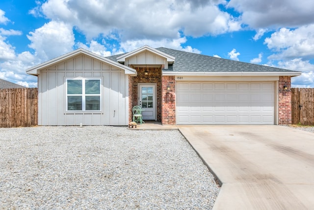 1501 Montague Ave, San Angelo, TX 76905 - single story home with board and batten siding, concrete driveway, brick siding, and a garage