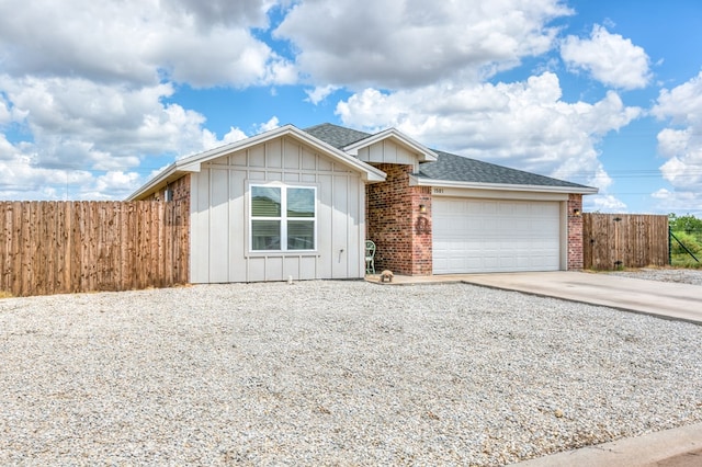 1501 Montague Ave, San Angelo, TX 76905 - ranch-style home featuring driveway, board and batten siding, a garage, and a shingled roof