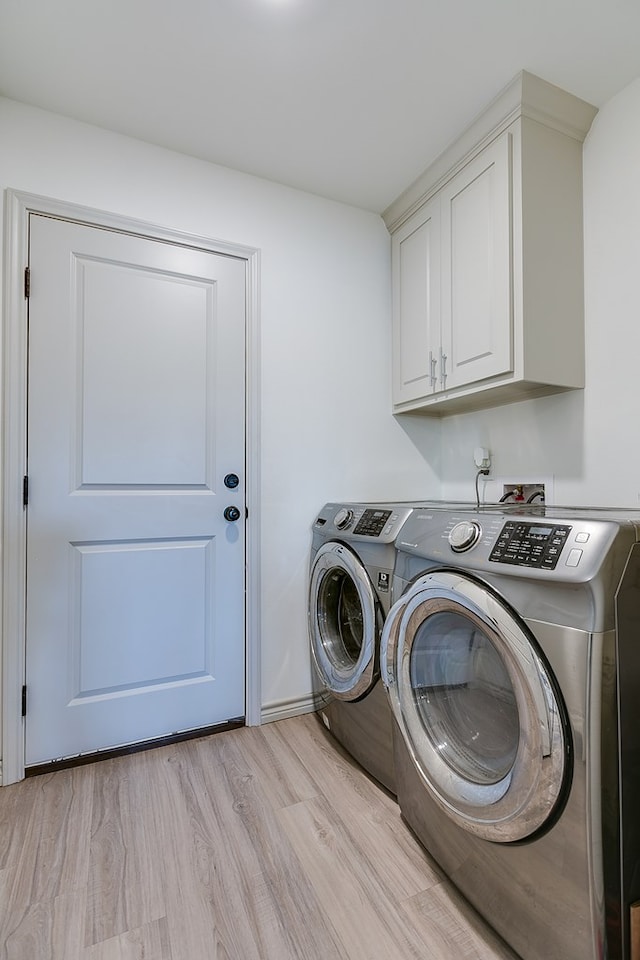 1501 Montague Ave, San Angelo, TX 76905 - laundry area featuring cabinet space, washing machine and dryer, and light wood-type flooring