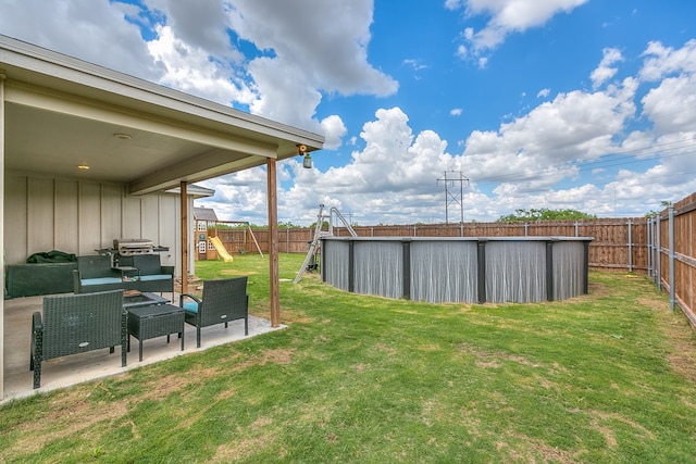1501 Montague Ave, San Angelo, TX 76905 - fenced backyard with a playground, a patio area, a swimming pool, and an outdoor living space