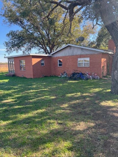 view of property exterior with a lawn