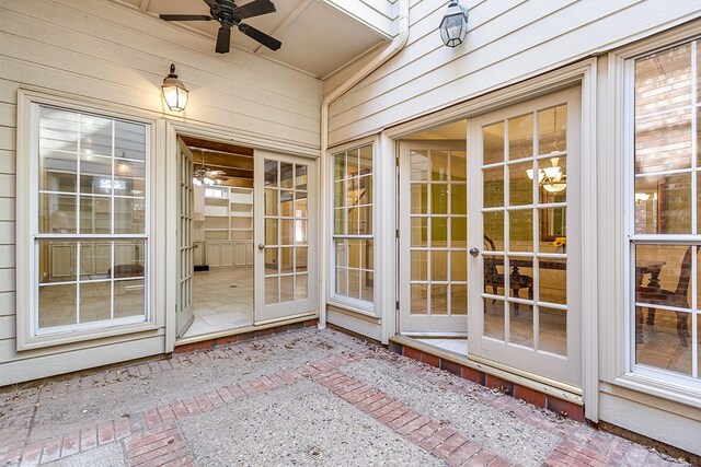 unfurnished sunroom with ceiling fan