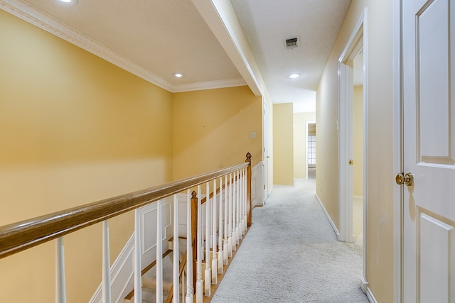 corridor featuring ornamental molding and light carpet