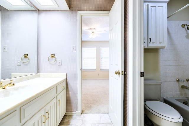 full bathroom featuring tile patterned flooring, vanity,  shower combination, and toilet