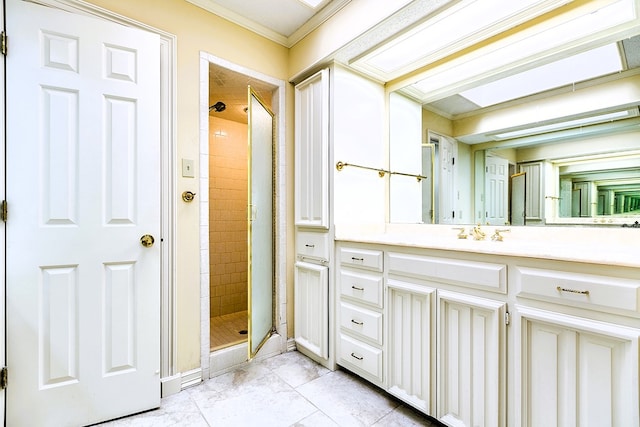 bathroom with vanity, crown molding, and a shower with shower door