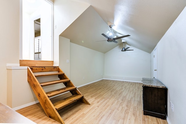 additional living space with vaulted ceiling, ceiling fan, and light wood-type flooring