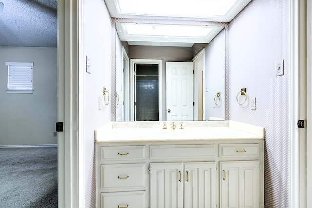 bathroom with vanity and a textured ceiling