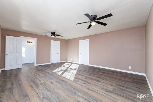 1611 Mission Ave, San Angelo, TX 76905 - spare room featuring a ceiling fan, baseboards, and dark wood-style flooring